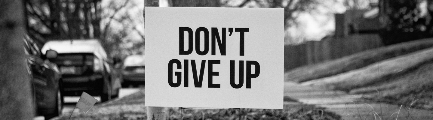 Don't give up sign in street